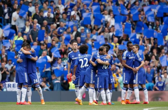 An image of Chelsea Football Club players congratualting each other ahead of a game